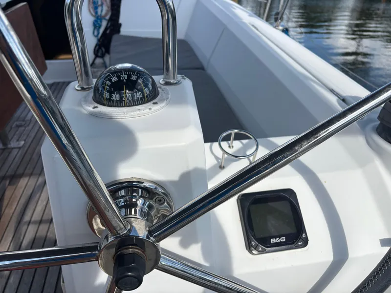Slide: The Image of Steering wheel and compass on 2015 Beneteau Oceanis 35 sailboat deck. - 7