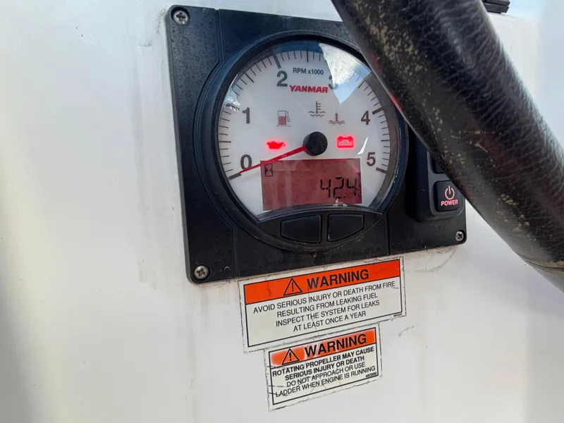 Slide: The Image of Yanmar engine gauge on 2015 Beneteau Oceanis 35 sailboat with warning labels. - 9