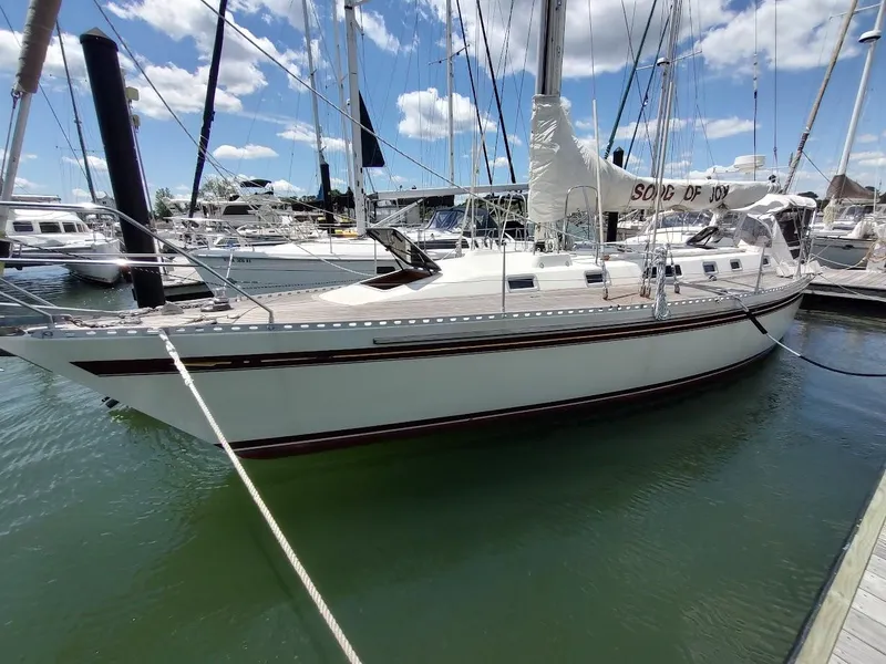 The Image of 1982 Ta Shing Tatoosh 42 sailboat docked in marina under blue sky. - 0