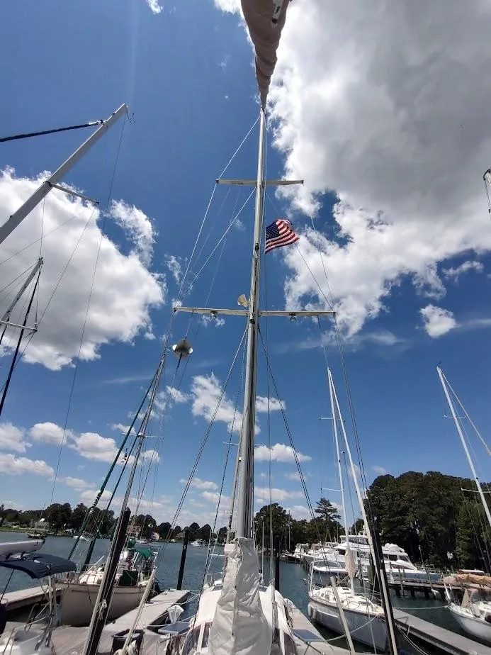 Slide: The Image of Sailboat mast with American flag, clear sky, Ta Shing Tatoosh 42, 1982 model. - 12