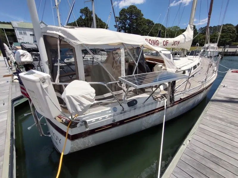 Slide: The Image of 1982 Ta Shing Tatoosh 42 sailboat docked, featuring solar panel and covered cockpit. - 3