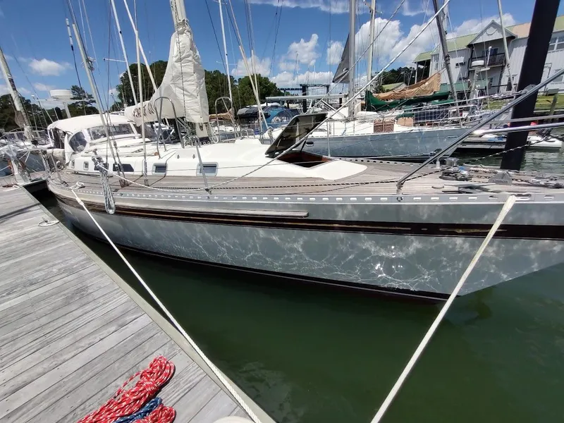 Slide: The Image of 1982 Ta Shing Tatoosh 42 sailboat docked at marina under clear blue sky. - 4