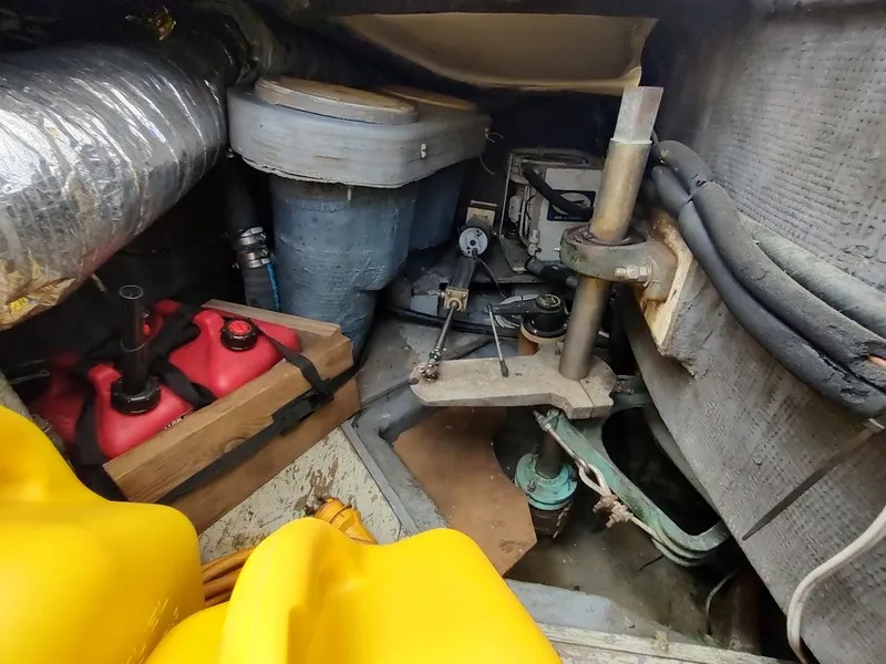 Slide: The Image of Engine room of 1982 Ta Shing Tatoosh 42 sailboat with fuel containers and mechanical components. - 46