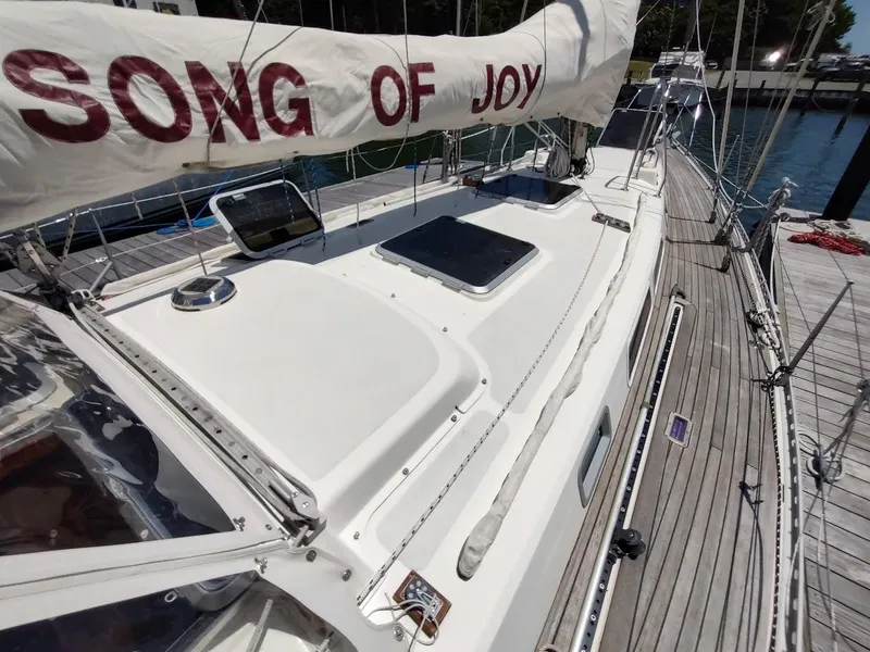 Slide: The Image of 1982 Ta Shing Tatoosh 42 sailboat deck with "Song of Joy" on sail. - 5