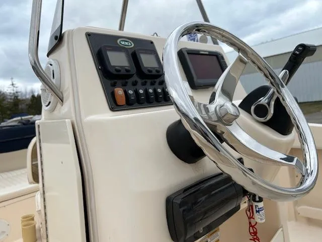 Slide: The Image of 2013 Grady-White Fisherman 180 boat console with steering wheel and control panel. - 14