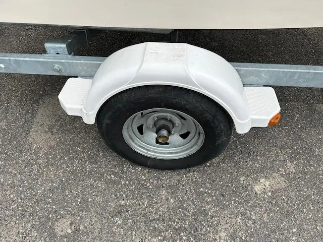 Slide: The Image of Trailer wheel of 2013 Grady-White Fisherman 180 on asphalt surface. - 4