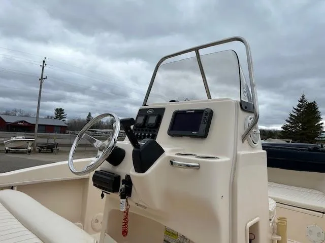 Slide: The Image of 2013 Grady-White Fisherman 180 boat console with steering wheel and navigation equipment. - 8