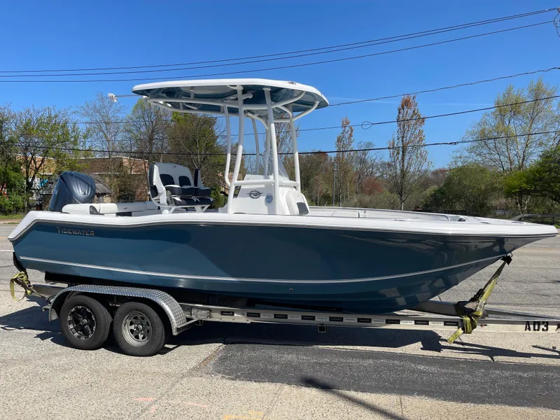 The Image of 2025 Tidewater 210 LXF boat on trailer, side view, outdoors, clear sky. - 1