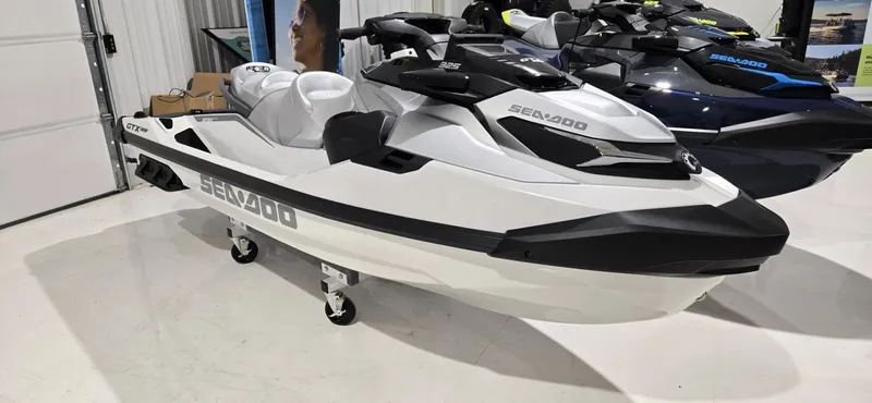 The Image of 2025 Sea-Doo GTX Limited 325 jet ski in showroom, white and black design. - 1