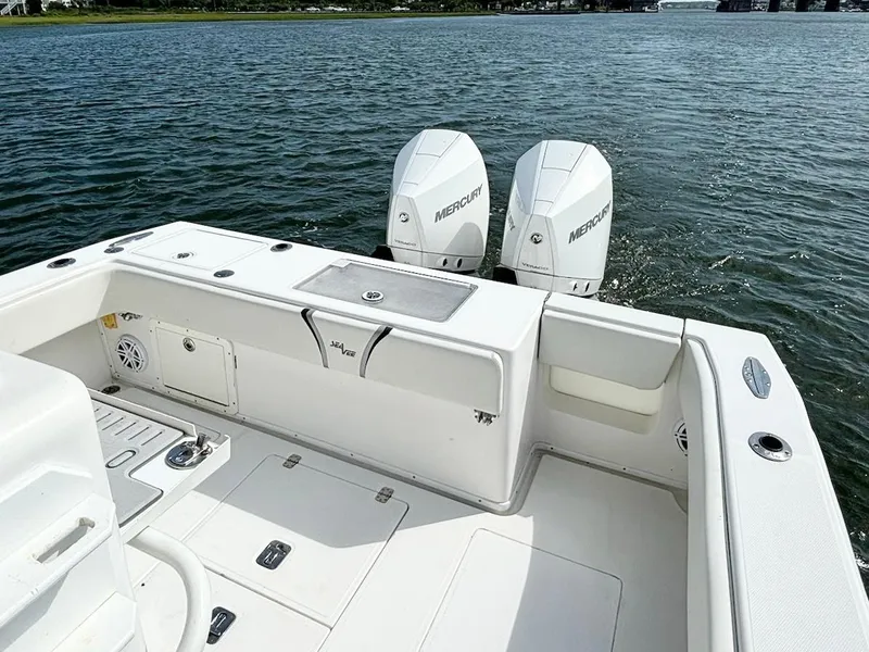 Slide: The Image of 2004 SeaVee 310B boat with dual Mercury engines on calm water. - 17