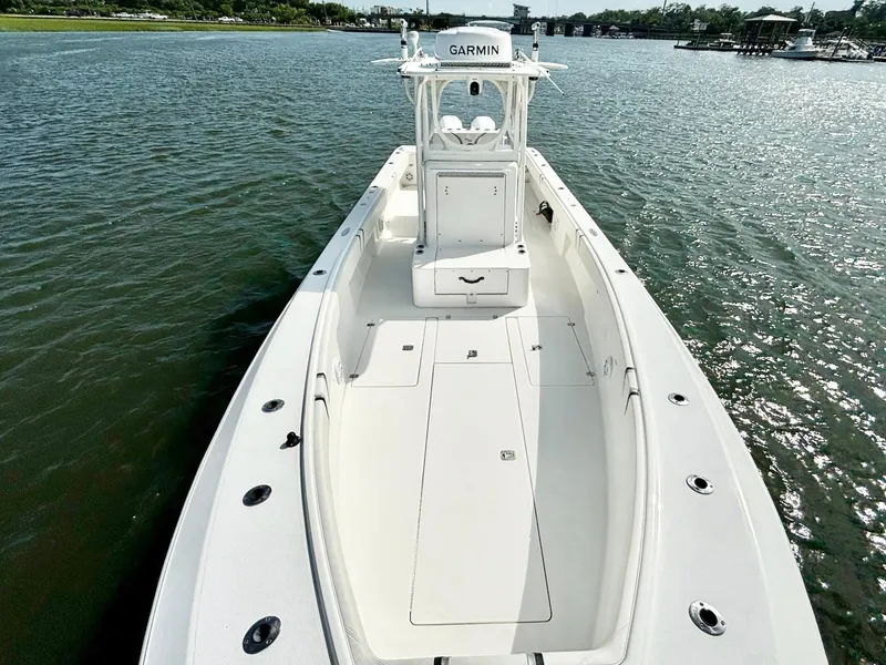 Slide: The Image of 2004 SeaVee 310B boat on water, featuring spacious deck and Garmin equipment. - 18