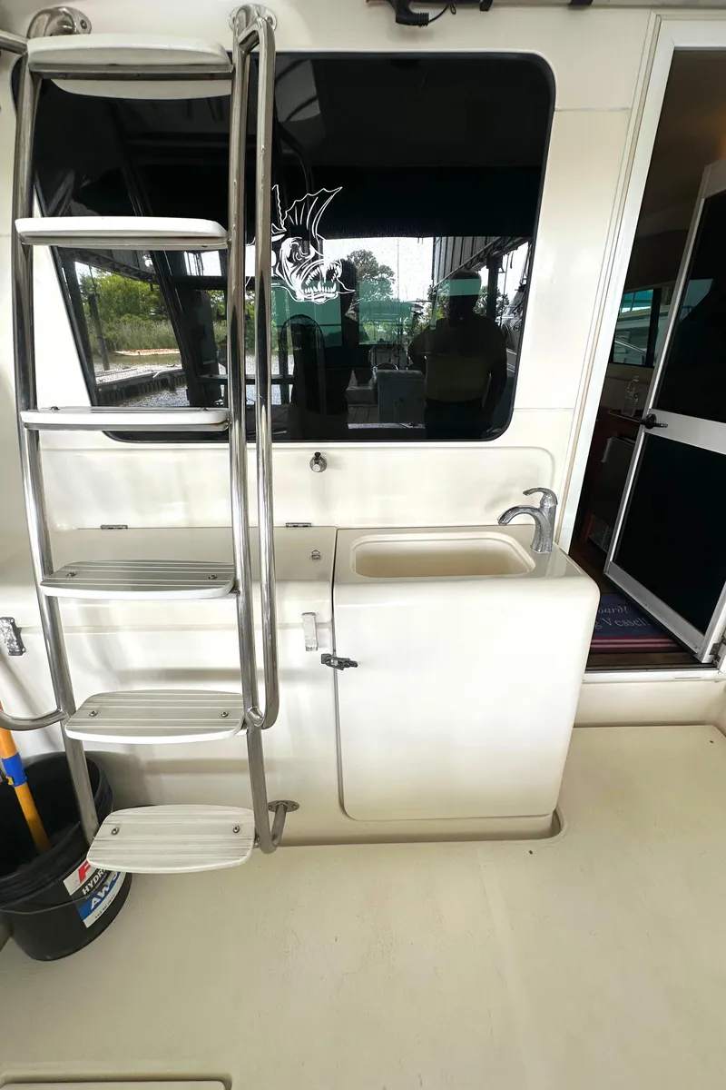 Slide: The Image of 2002 Riviera 350 yacht interior with ladder and sink area. - 13