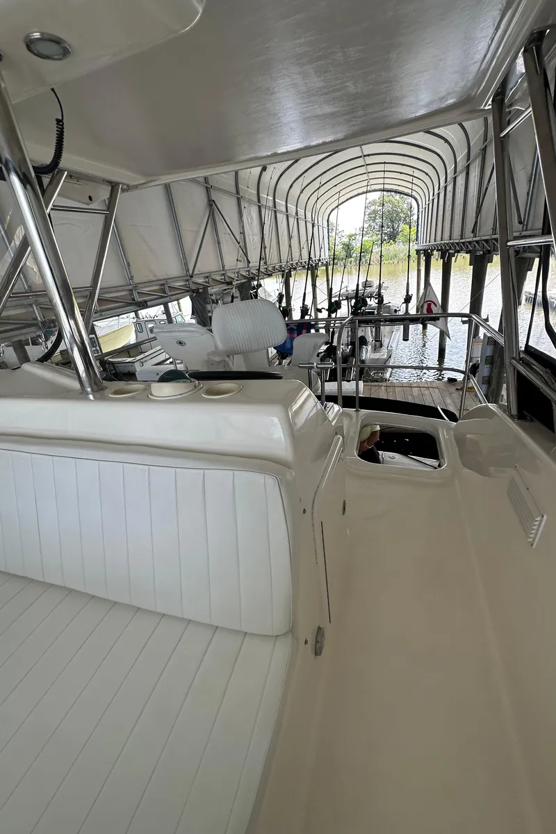 Slide: The Image of 2002 Riviera 350 boat interior with covered deck and seating area. - 18