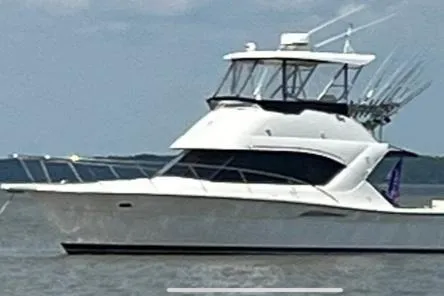 Slide: The Image of 2002 Riviera 350 yacht on calm waters with fishing rods. - 2