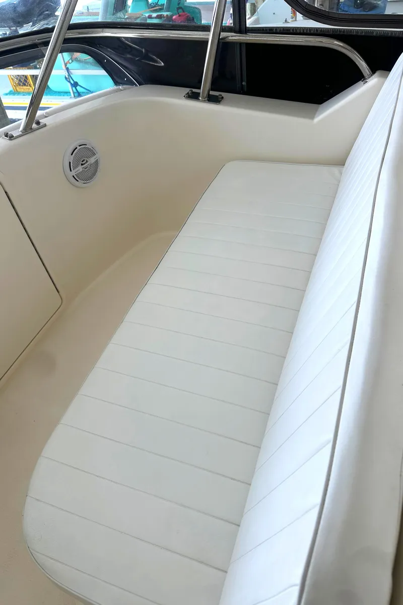 Slide: The Image of 2002 Riviera 350 boat interior with white cushioned seating. - 20