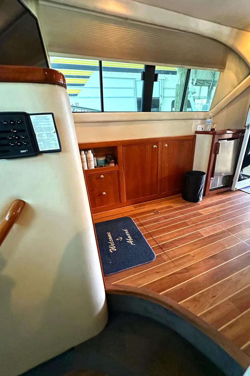Slide: The Image of Interior of 2002 Riviera 350 yacht with wooden flooring and cabinetry. - 33