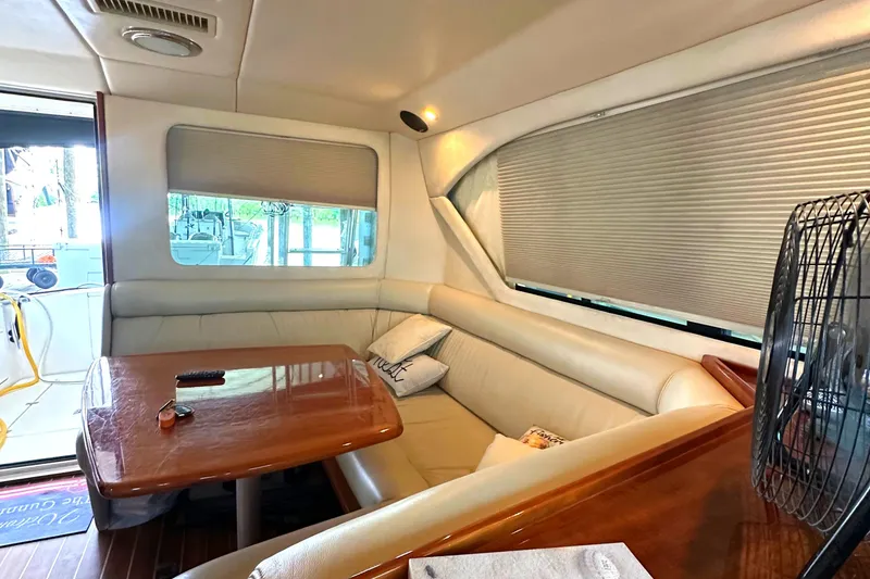 Slide: The Image of Interior of a 2002 Riviera 350 yacht with a cozy dining area and wooden table. - 34
