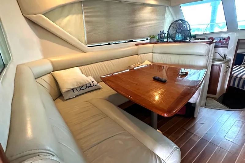 Slide: The Image of Luxurious interior of a 2002 Riviera 350 yacht with leather seating and wooden table. - 38
