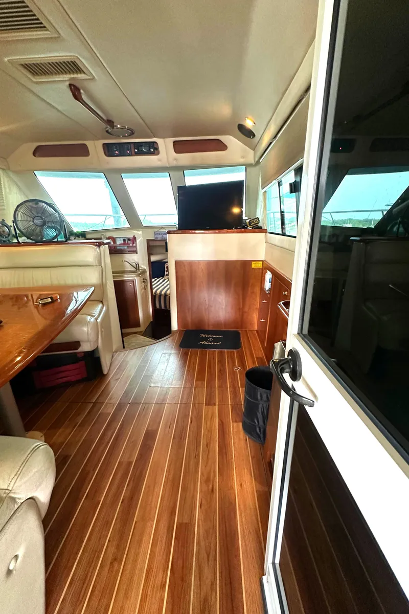 Slide: The Image of Interior of a 2002 Riviera 350 yacht with wooden flooring and modern amenities. - 39