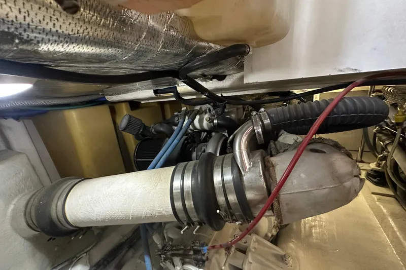 Slide: The Image of Engine compartment of a 2002 Riviera 350 boat, showcasing exhaust and ventilation components. - 40