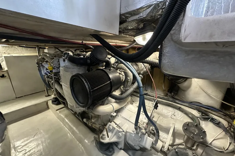 Slide: The Image of Engine room of a 2002 Riviera 350 boat, showcasing mechanical components and wiring. - 41