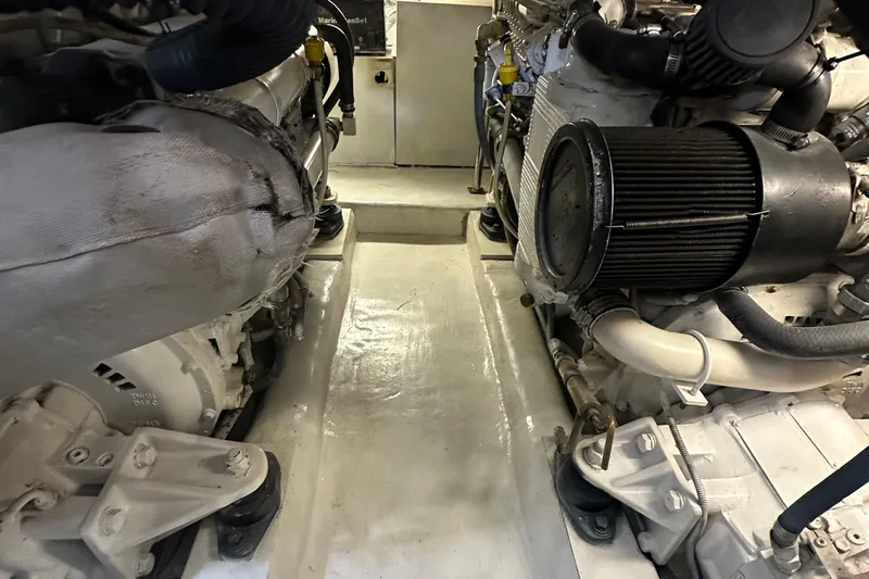 Slide: The Image of Engine room of a 2002 Riviera 350 boat, showcasing dual engines and mechanical components. - 42