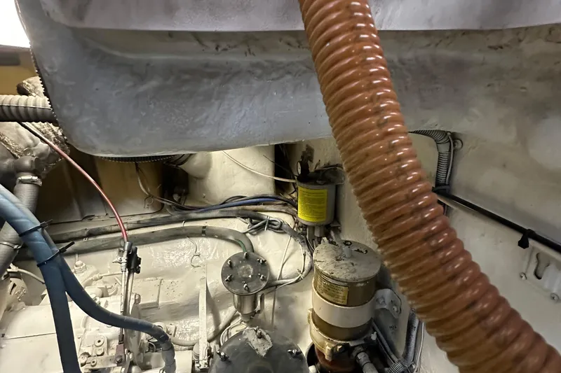 Slide: The Image of Engine room of a 2002 Riviera 350 boat, showing hoses and mechanical components. - 43