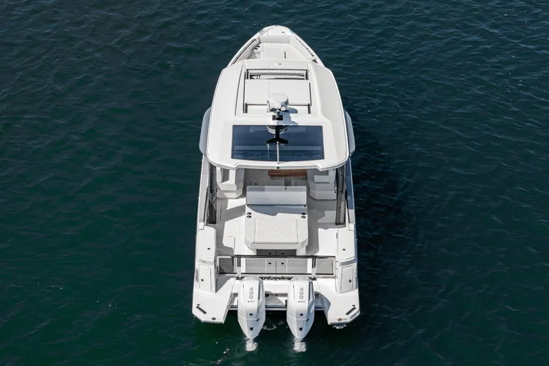 Slide: The Image of 2025 Saxdor 400 GTO boat on water, aerial view, showcasing sleek design and twin engines. - 16