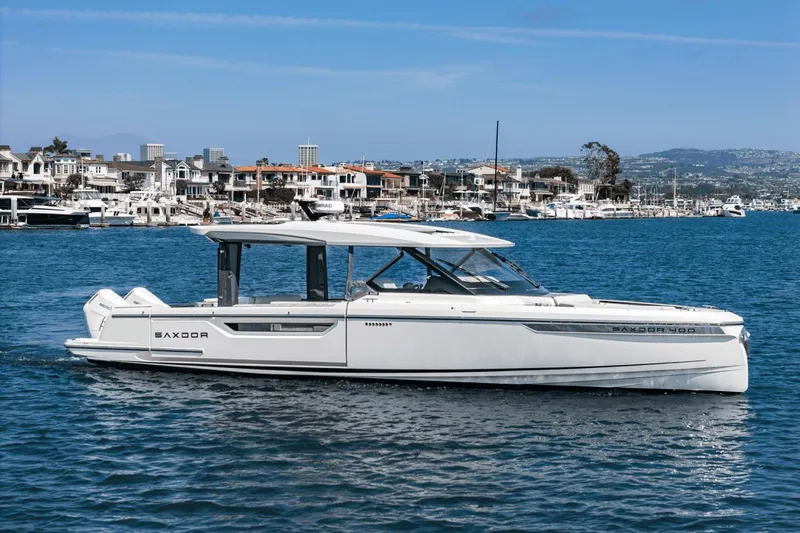 Slide: The Image of 2025 Saxdor 400 GTO luxury boat cruising in a scenic marina setting. - 3