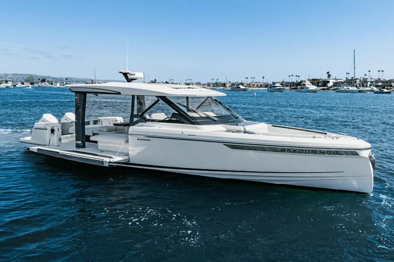 Slide: The Image of 2025 Saxdor 400 GTO luxury yacht cruising on a sunny day in a marina. - 4