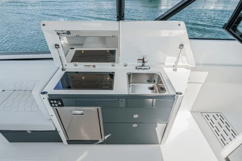 Slide: The Image of Modern kitchen area on 2025 Saxdor 400 GTO yacht with stove, sink, and storage. - 40