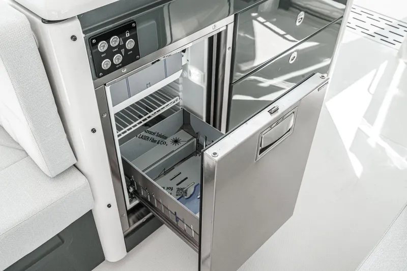 Slide: The Image of Saxdor 400 GTO 2025 yacht interior with open stainless steel drawer and control panel. - 42