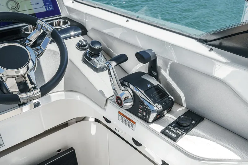 Slide: The Image of 2025 Saxdor 400 GTO helm with modern controls and steering wheel, on open water. - 46