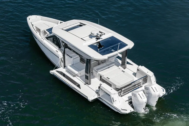 Slide: The Image of 2025 Saxdor 400 GTO luxury boat cruising on open water, showcasing sleek design and twin engines. - 9