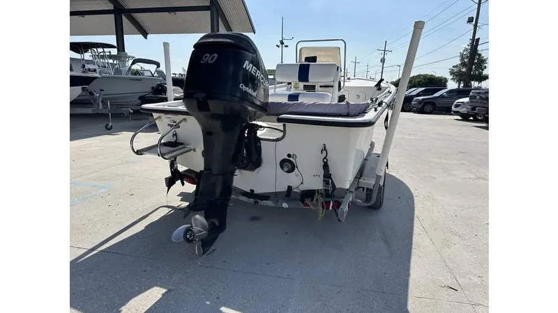 Slide: The Image of 2009 Trophy 181 Bay boat with Mercury outboard motor, parked on a trailer. - 10