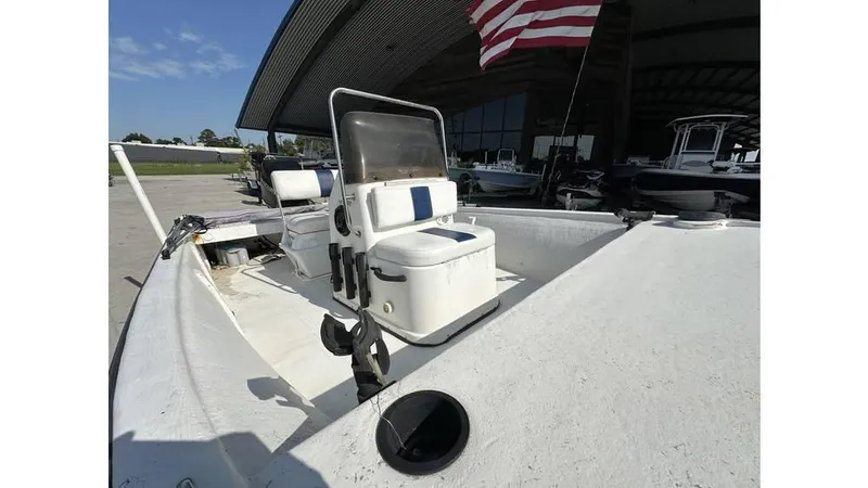 Slide: The Image of 2009 Trophy 181 Bay boat with seating, docked under a large canopy. - 12