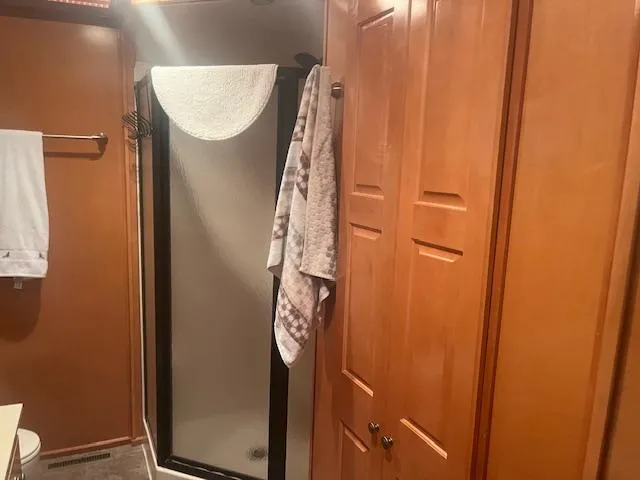 Slide: The Image of Bathroom interior of 2009 Horizon 18 x 85 Houseboat with shower and wooden cabinetry. - 20