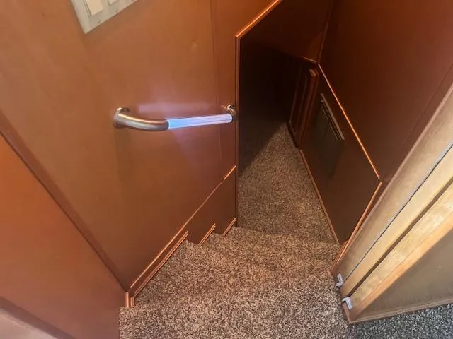 Slide: The Image of Staircase inside 2009 Horizon 18 x 85 Houseboat with carpeted steps and wooden handrail. - 24