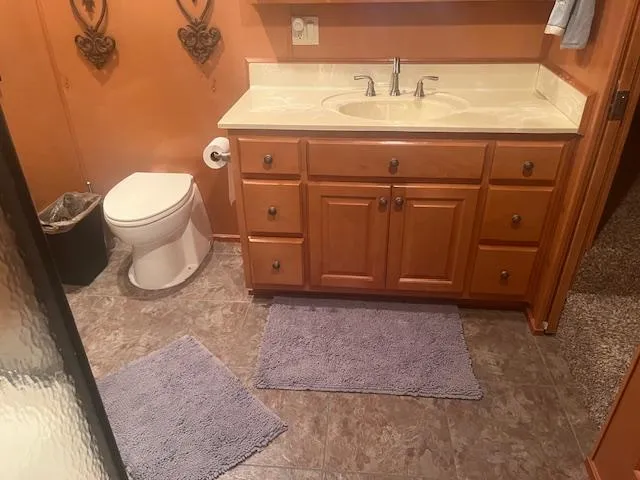 Slide: The Image of Bathroom interior of 2009 Horizon 18 x 85 Houseboat with wooden cabinets and orange walls. - 25