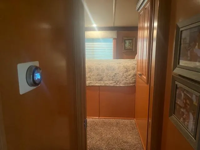 Slide: The Image of Interior view of 2009 Horizon 18 x 85 Houseboat bedroom with thermostat set to 74 degrees. - 29