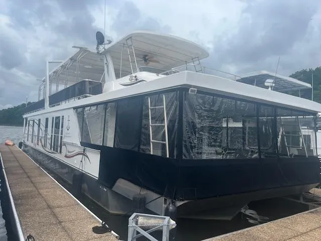 Slide: The Image of 2009 Horizon 18 x 85 houseboat docked under cloudy skies. - 3