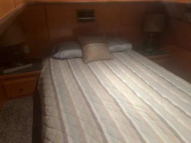 Slide: The Image of Cozy bedroom in 2009 Horizon 18 x 85 houseboat with striped bedding and decorative pillows. - 30