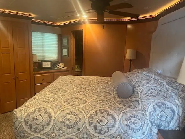 Slide: The Image of Luxurious bedroom interior of 2009 Horizon 18 x 85 Houseboat with elegant bedding and warm lighting. - 32