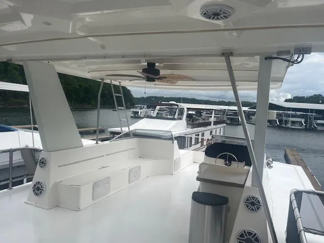 Slide: The Image of 2009 Horizon 18 x 85 Houseboat with spacious deck and seating, docked at marina. - 42