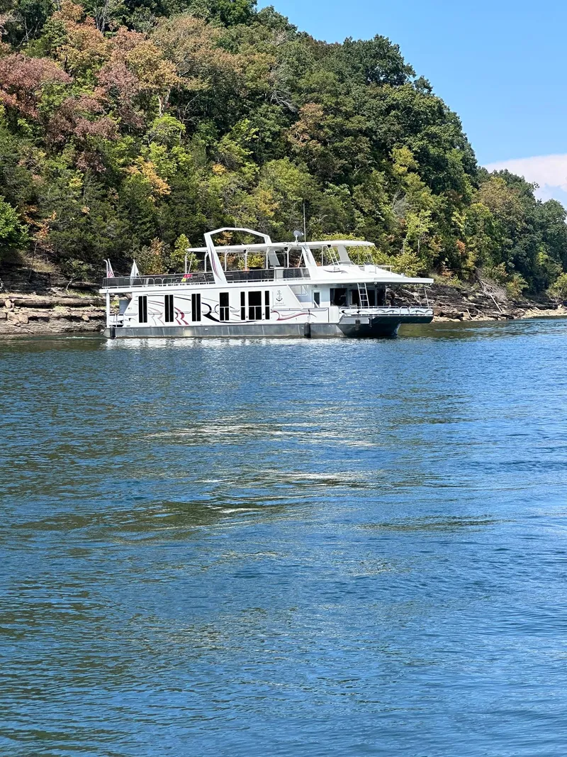 Slide: The Image of 2009 Horizon 18 x 85 Houseboat on a scenic lake with lush green shoreline. - 6
