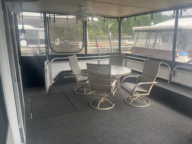 Slide: The Image of 2009 Horizon 18 x 85 Houseboat interior with table and chairs on deck. - 7
