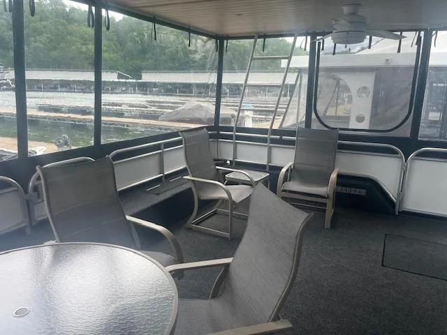 Slide: The Image of Spacious 2009 Horizon 18 x 85 houseboat interior with seating and glass table. - 8