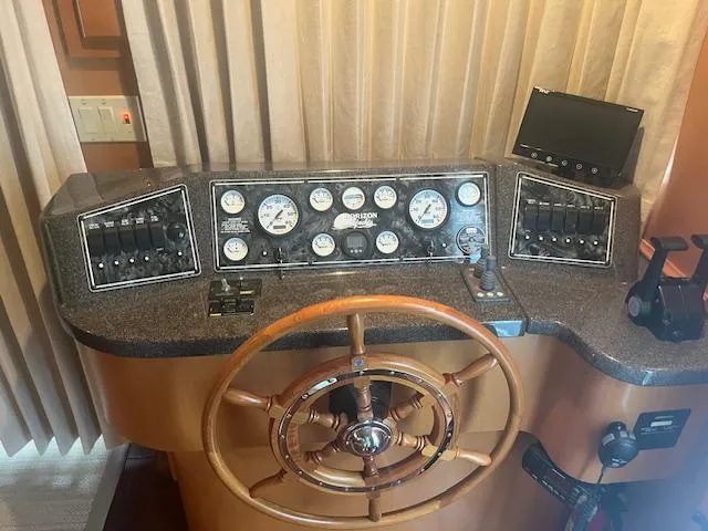 Slide: The Image of Control panel of a 2009 Horizon 18 x 85 Houseboat with wooden steering wheel. - 9