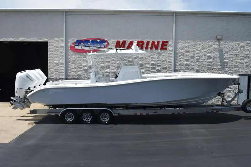 The Image of 2024 Yellowfin 36 Offshore boat on trailer outside marine dealership. - 1