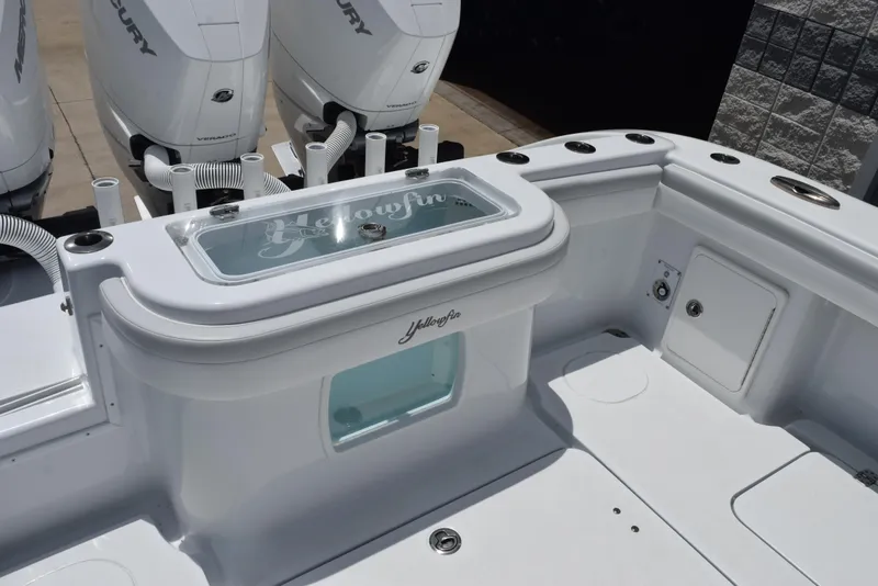 Slide: The Image of 2024 Yellowfin 36 Offshore boat deck with Mercury engines and storage compartments. - 10